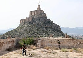Operarios, desbrozando la maleza acumulada en el recinto superior del Castillejo.