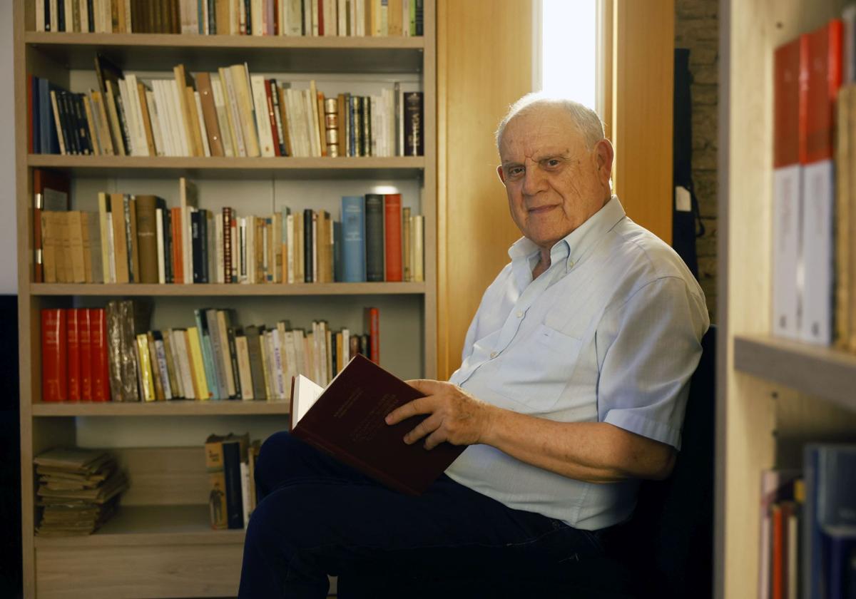 César Oliva posa con uno de los libros que forman parte de la nueva biblioteca de artes escénicas del Teatro Romea.