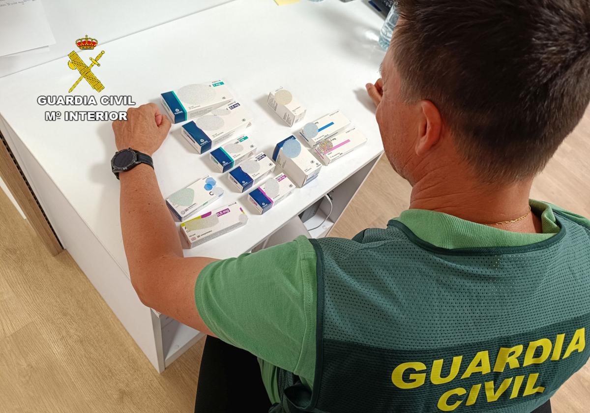 Un agente inspecciona cajas de medicamentos intervenidos.