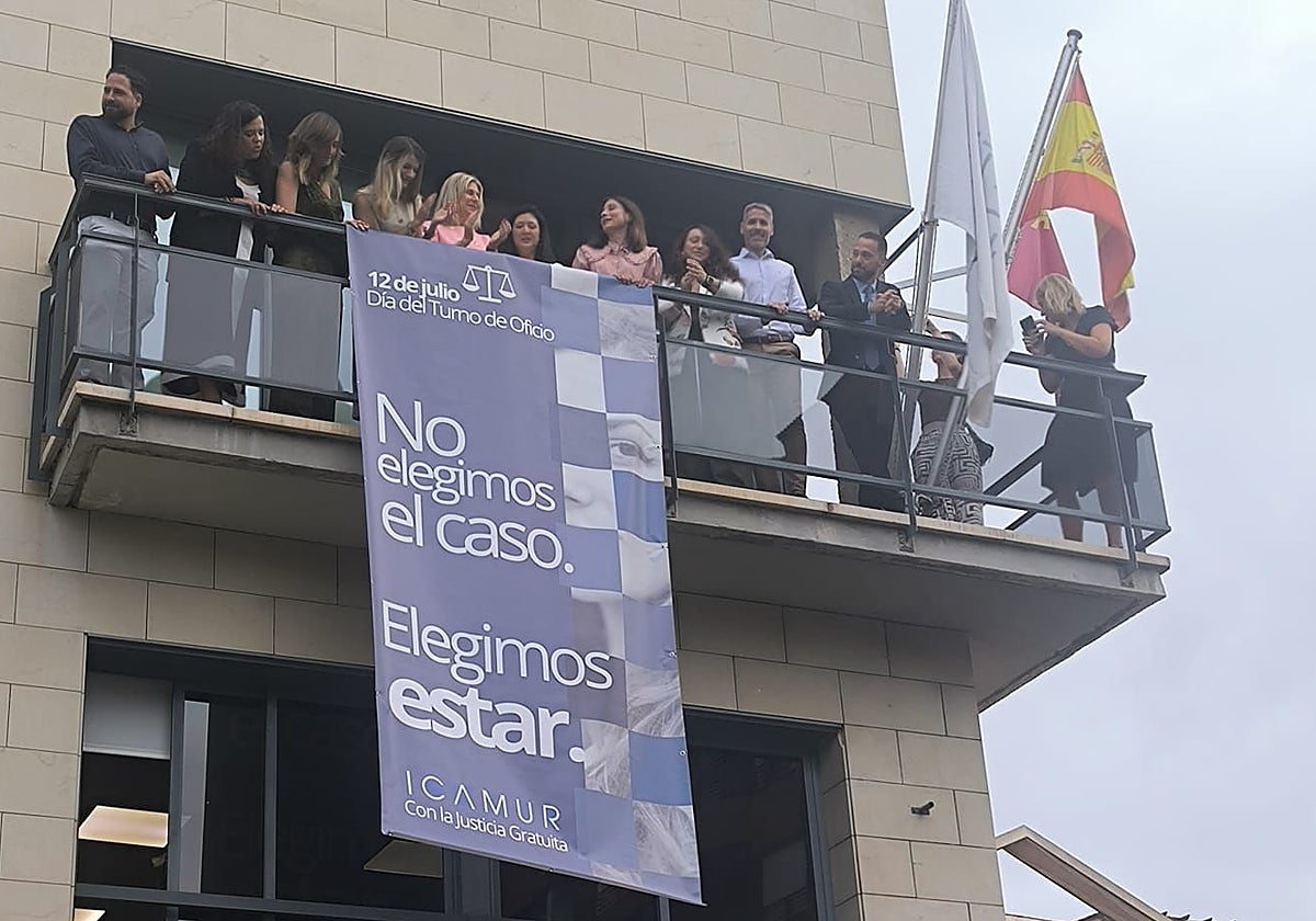 La junta directiva del Colegio desplegando una pancarta este viernes en defensa del turno de oficio.