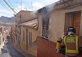 Los bomberos, este martes, en el incendio de la vivienda.