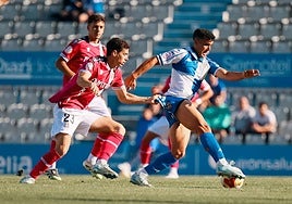 Nacho Sánchez agarrando a Joel Priego, jugador del Sabadell.