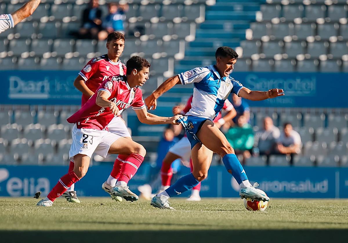 Nacho Sánchez agarrando a Joel Priego, jugador del Sabadell.