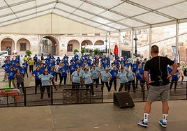 Los mayores siguen las instrucciones del monitor en la clase de gimnasia en la plaza de España.