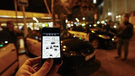 Un smartphone conectado a la aplicación Uber esperando a recibir algún cliente, cerca de la Sagrada Familia, en Barcelona.