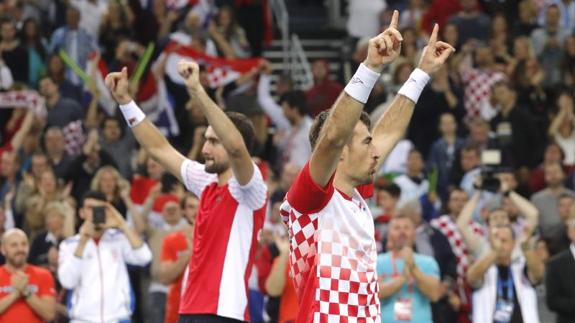 Marin Cilic e Ivan Dodig celebran su victoria en el dobles. 