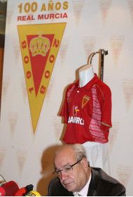 CENTENARIO. Arriba, Jesús Samper en la presentación oficial de la camiseta y el logo del Centenario del Real  Murcia; a la izquierda,  los consejeros del  club sostienen las dos versiones de la camiseta. / JUAN LEAL