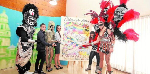 Representantes de las comparsas, ayer, con el cartel anunciador del Carnaval de Cabezo de Torres. 