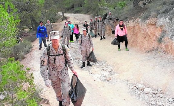 Voluntarios y militares en plena tarea de limpieza.