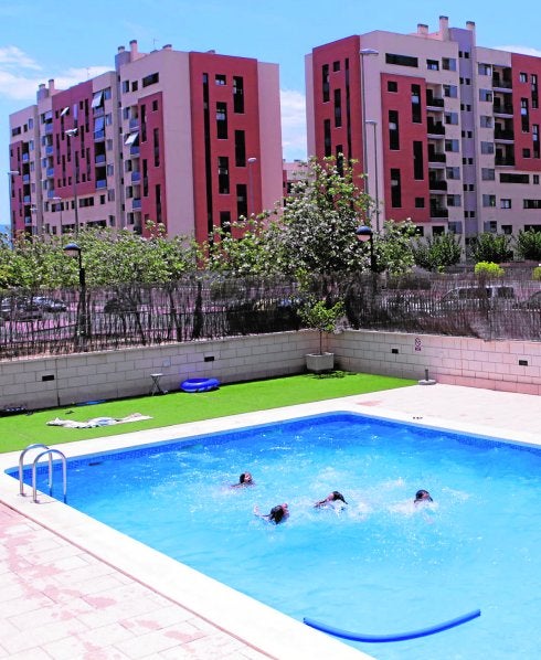 Unos niños se bañan en la piscina de uno de los bloques de viviendas de Joven Futura.