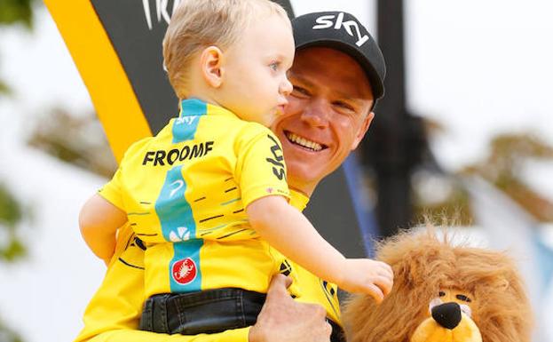 Chris Froome posa con su hijo en brazos en el podio de los Campos Elíseos