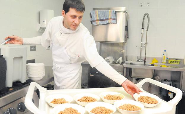 Víctor de la Serna distriibuye los platos para los niños de la guardería palentina. 