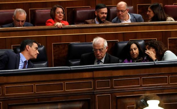 Sánchez conversa con la ministra María Jesús Montero en un momento del debate.