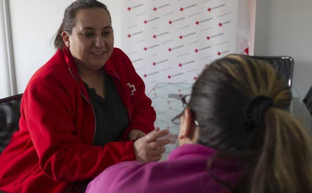 Paloma Martín, de espaldas, conversa con Nuria Alonso, técnico de Intervención Familiar de Cruz Roja Zamora.