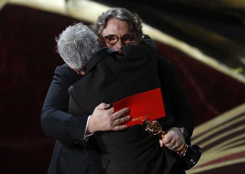 Guillermo del Toro abraza a su compatriota mexicano Alfonso Cuarón tras entregarle el Oscar al 'mejor director' por 'Roma'.
