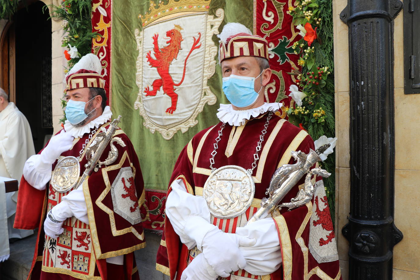 Unas mujeres reciben la comunión mientras portan mascarillas.