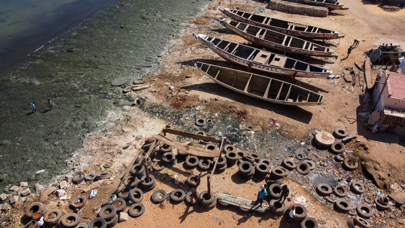 El agua contaminada con aguas residuales fluye a través de canales abiertos hacia el océano de la bahía de Hann, en el extremo este de la península de Dakar, cuyo litoral arenoso está descolorido por algas estancadas.