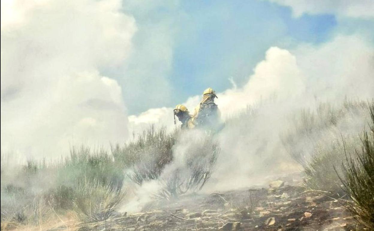 Dos bomberos trabajan en las labores de extinción del incendio en Boca de Huérgano.