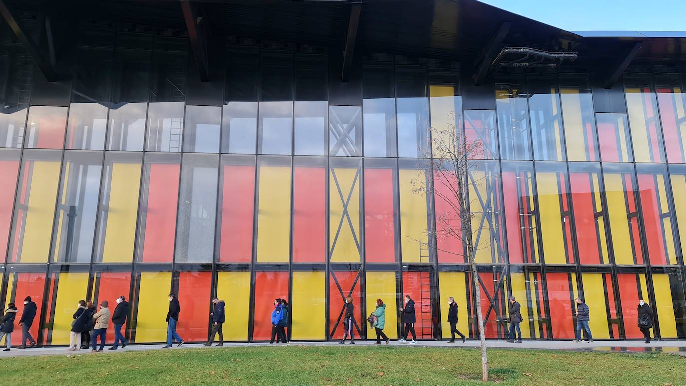 Una hora antes de la apertura de puertas en el 'vacunódromo' del Palacio de Exposiciones los leoneses 'de los 60' ya hacen cola para inocularse la tercera dosis | La cola, que ha llegado a alcanzar el kilómetro durante este martes, evidencia la alta respuesta al llamamiento. 