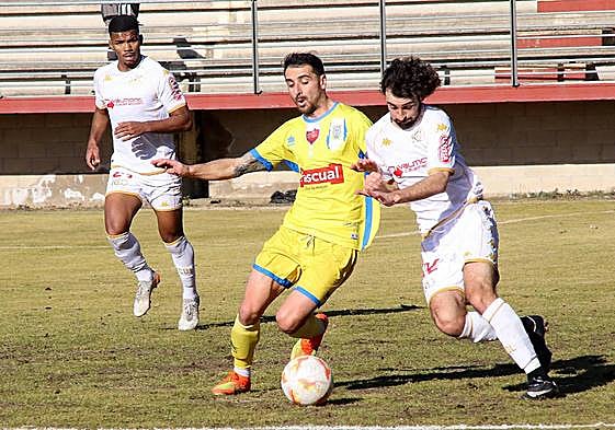 Un jugador del Júpiter y uno de la Arandina luchan por un balón.