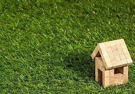 Casa en miniatura hecha por madera en el campo.