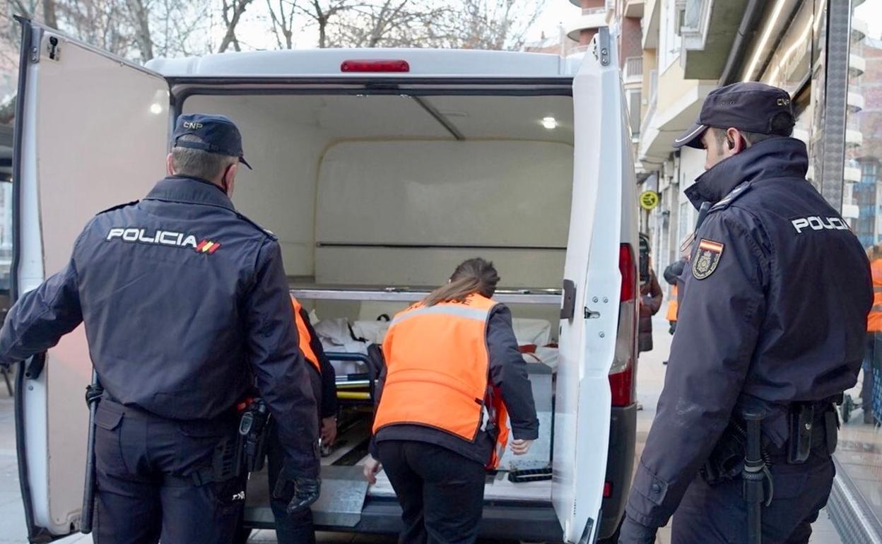 Efectivos policiales durante el traslado de los cuerpos desde el lugar del crimen. 