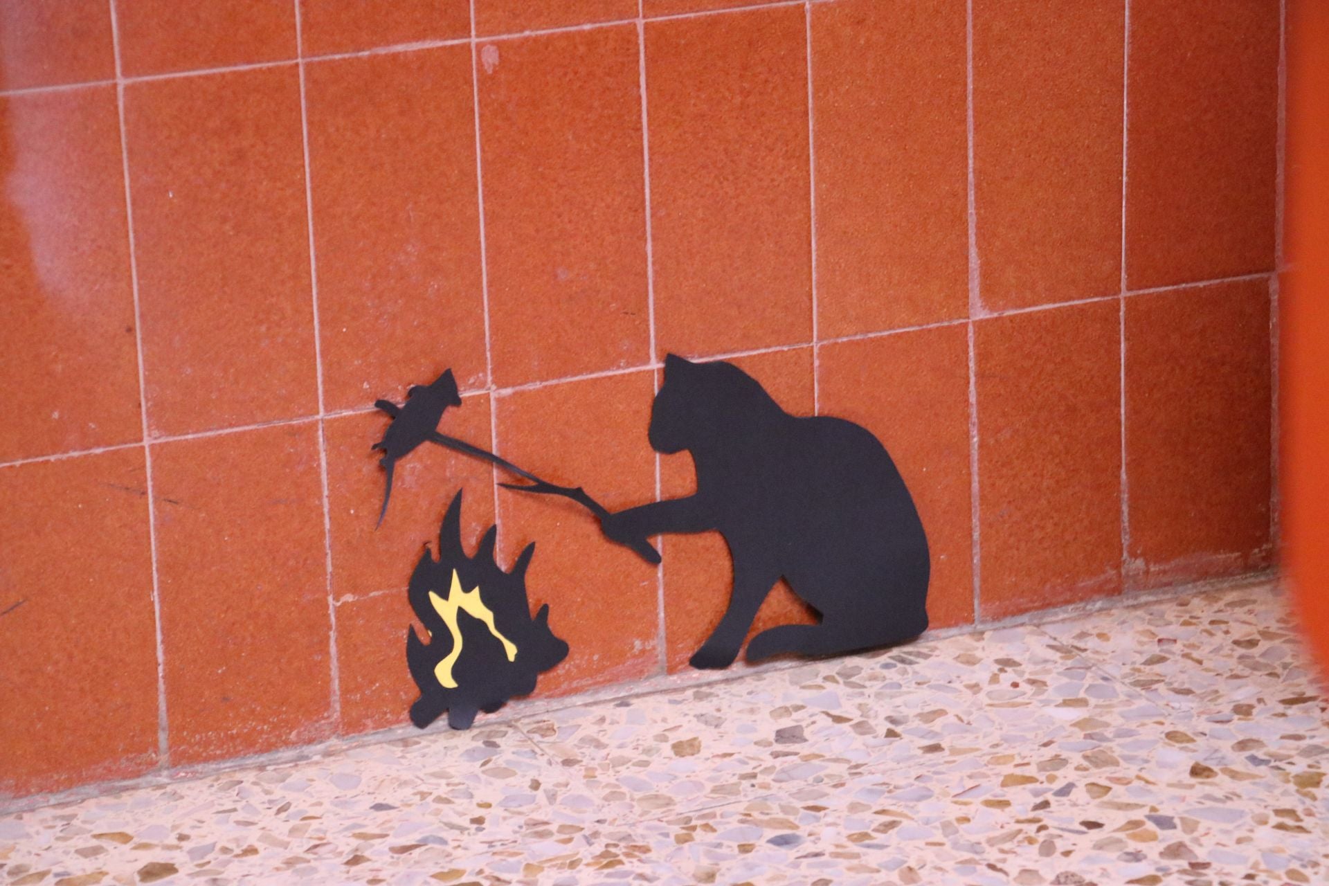 Decoración de los rincones del colegio con un gato atrapando a los ratones