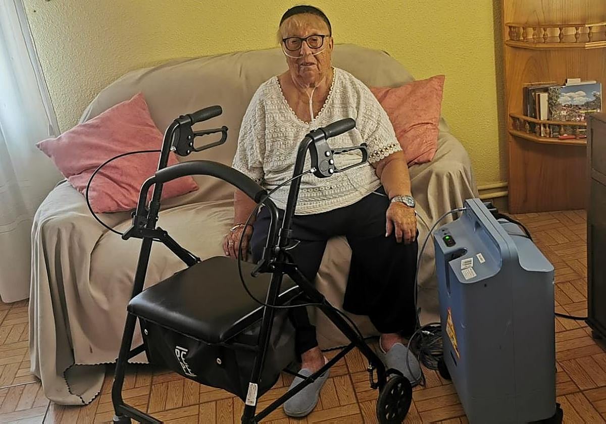 María Dolores Bayo vive conectada a un equipo de oxígeno y necesita de un andador para moverse.
