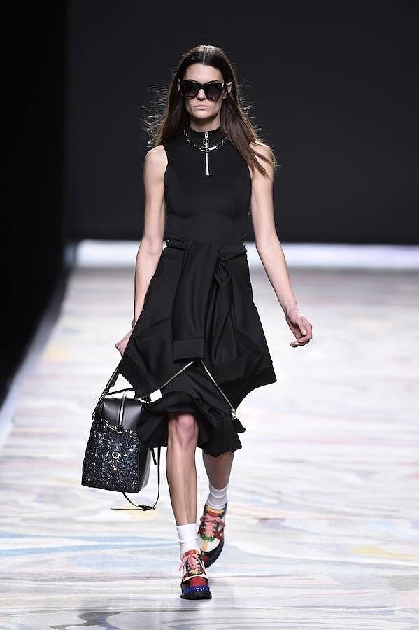 Vestido negro sin mangas con sudadera anudada.