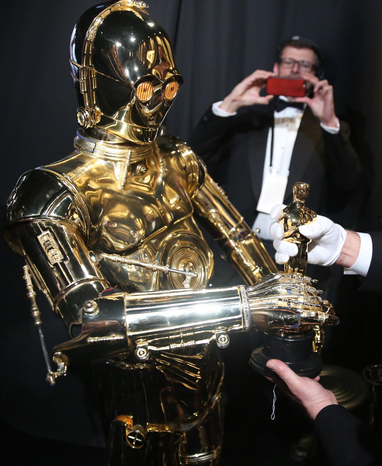 C-3PO entrega uno de los galardones de la noche y aprovecha su momento de gloria al sostener una estatuilla.