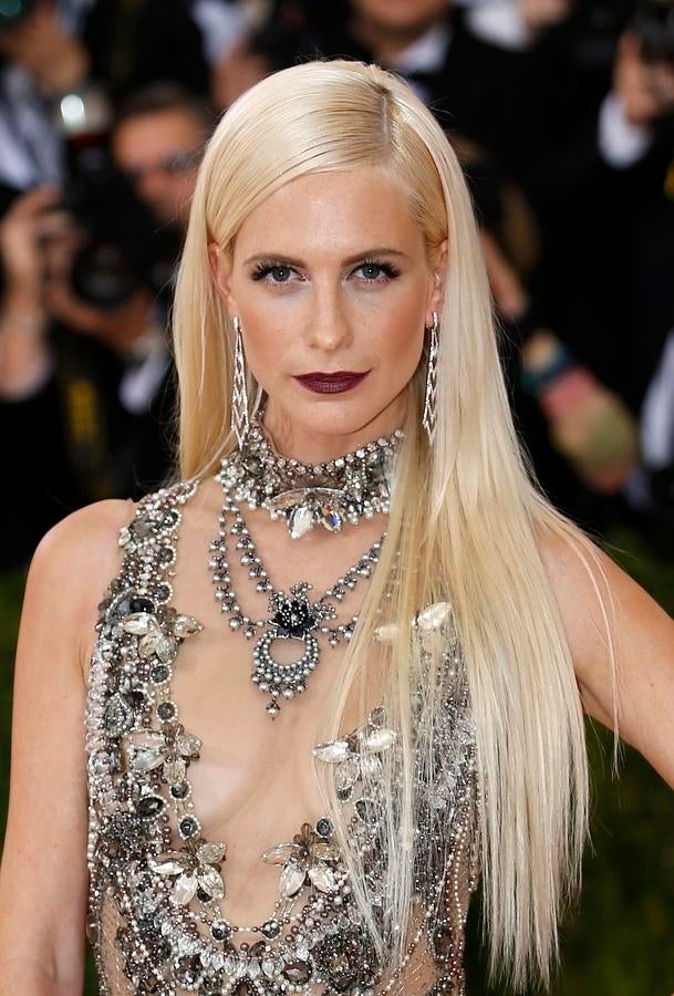 Poppy Delevingne con melena platino extra lisa y XXL, peinada con raya lateral. y labios 'vamp', un contraste perfecto con su color de piel y de pelo.