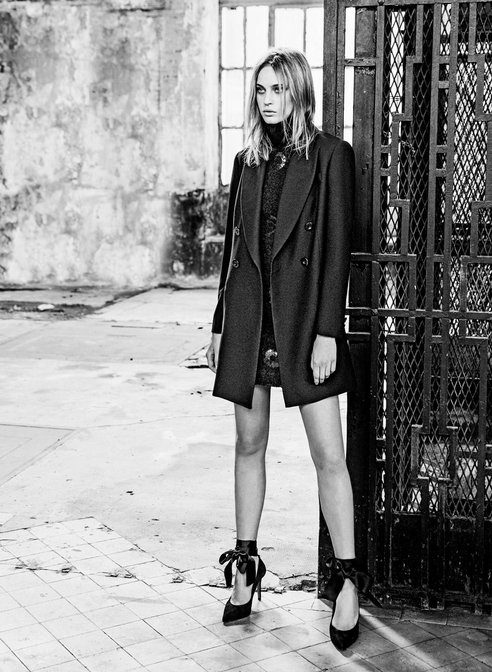 Vestido de charol, abrigo corto y zapatos con lazada de seda al tobillo.