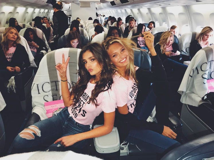 Taylor Hill y Romee Strijd posando desde sus asientos.