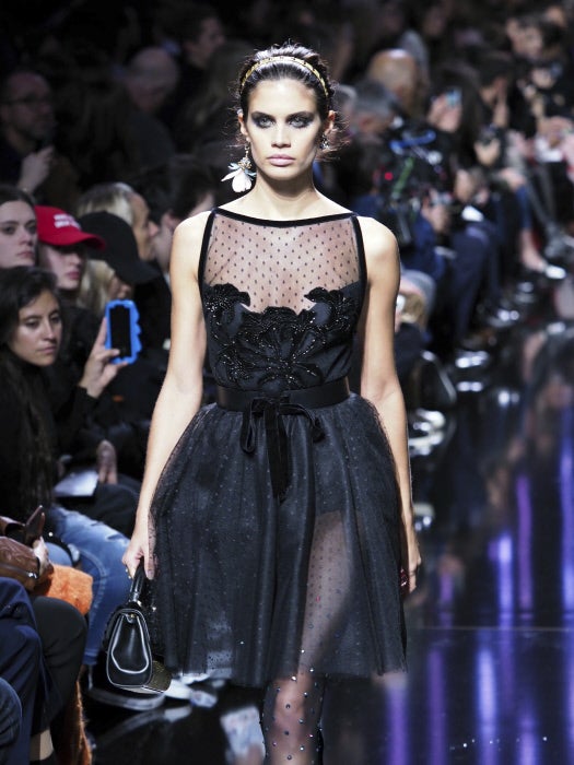 Los vestidos románticos de tul, como éste que lleva a modelo portuguesa Sara Sampaio, brillan gracias a los cristales con los que estás confeccionados, que incluso llegan a decorar también las medias negras de cristal.