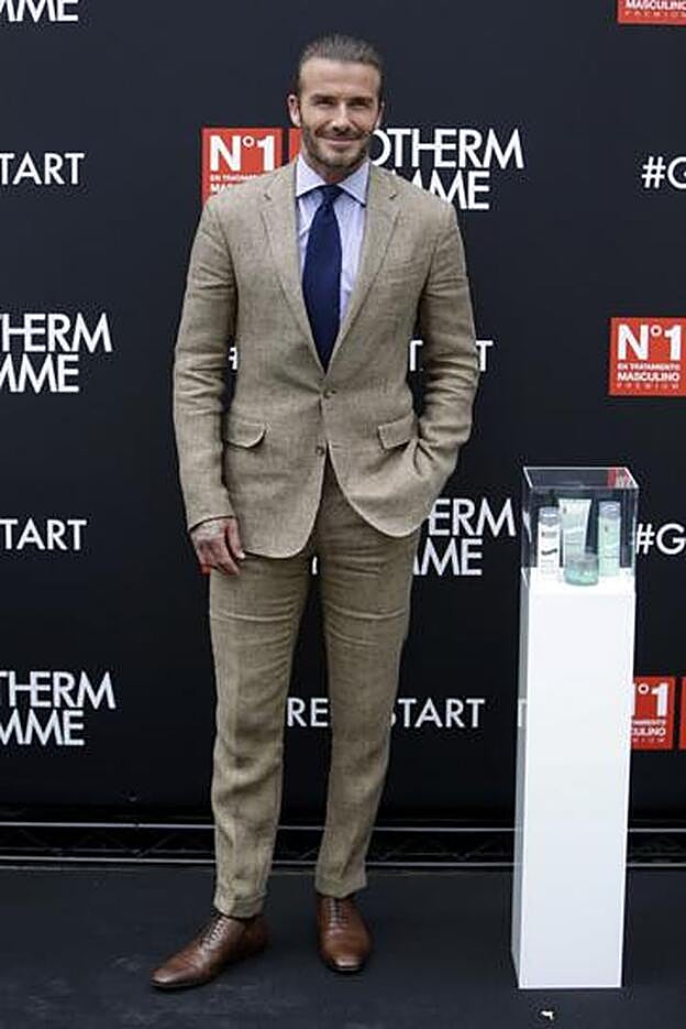 David Beckham posando en el photocall siempre sonriendo.