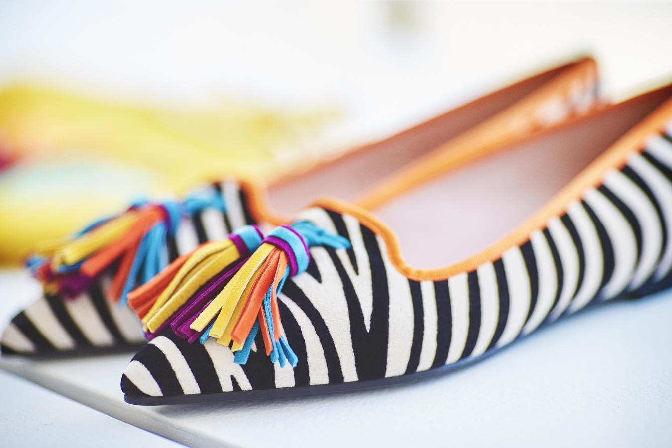 'Ella tutti futti tassel' es este original diseño en estampado de cebra con borlones multicolor que a Olivia le encanta utilizar para romper looks en tonos básicos.