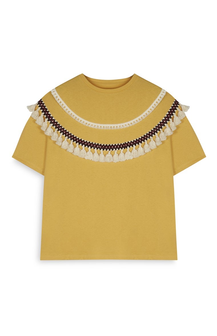 Top con borlones de Primark. Precio: 10 euros.
