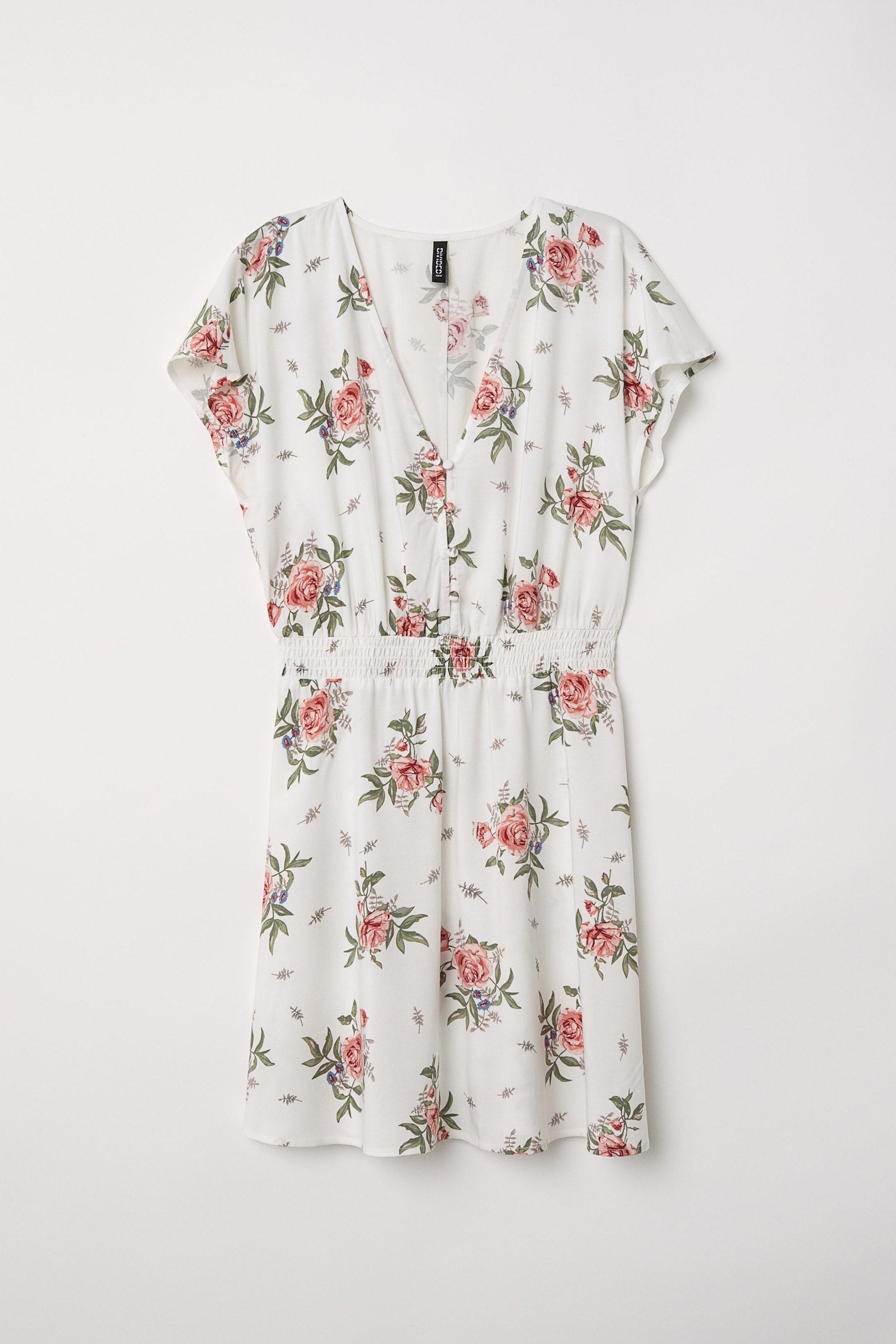 Vestido mini de H&M con botones y cintura elástica. (19,99 euros).