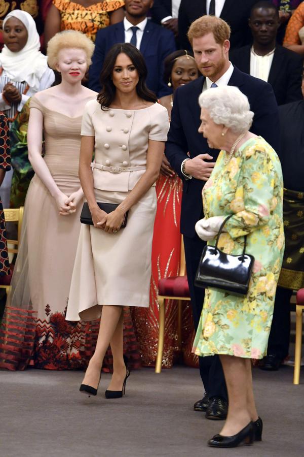 Para una recepción junto a la Reina de Inglaterra en Buckingham eligió un traje de dos piezas con chaqueta de manga corta y grandes botones, de Prada
