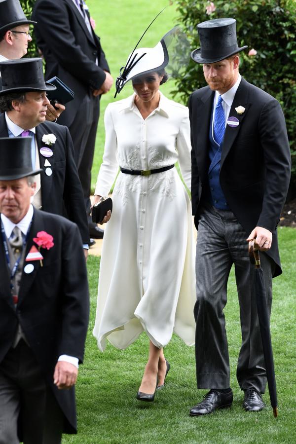 De blanco y negro, con tocado, como dicta el protocolo, Meghan Markle se  estrenaba  en las carreras de Ascot con este vestido camisero con bordados de Givenchy.