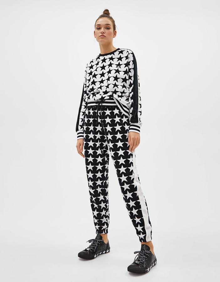 En contraste blanco/negro, con estampado de estrellas y banda lateral combinada a contraste en las mangas y en la pernera (70+75 euros).