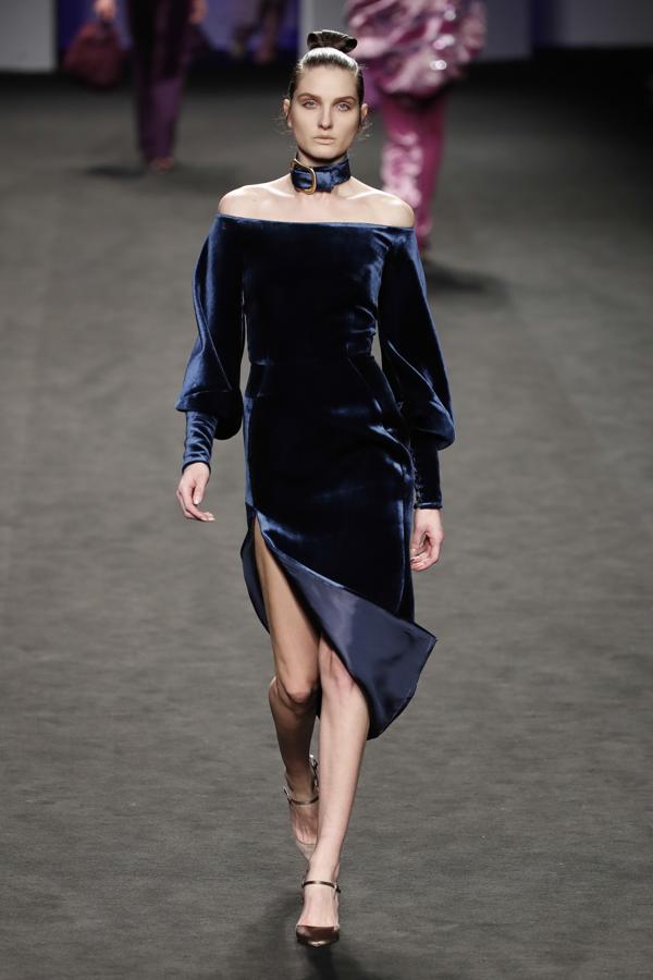 Este elegante vestido de terciopelo azul noche y escote 'off the shoulders' de Marcos Luengo, perfecto para una cena de gala.