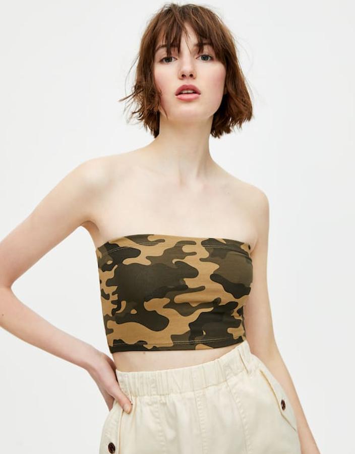Top 'bandeau' en 'estampados camuflaje y en tejido elástico (3,99 euros), combinado con un pantalón cargo con elástico en la cintura (19,99 euros).