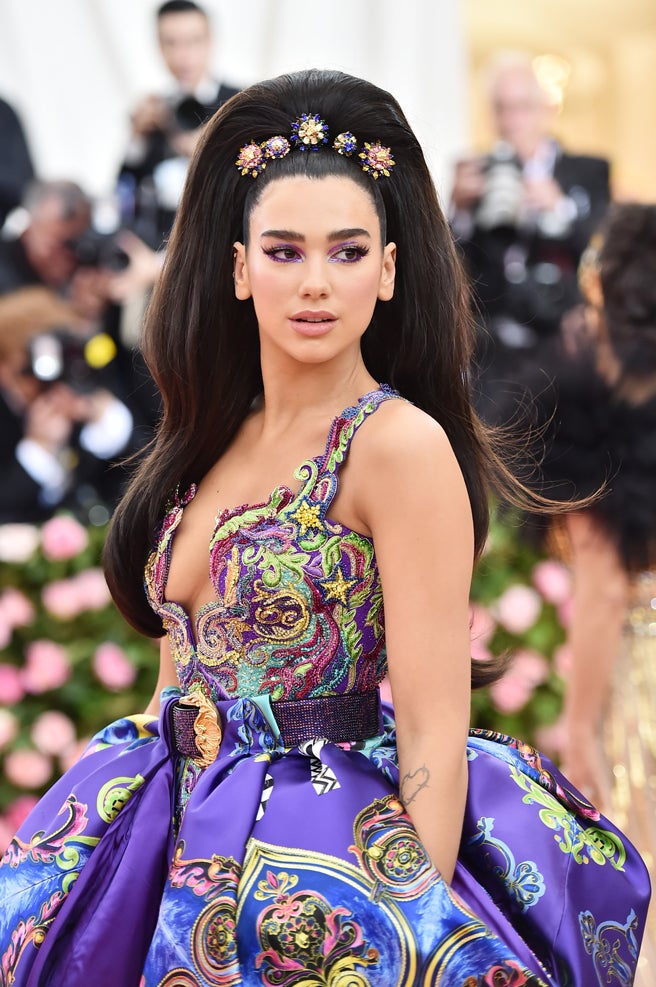 El volumen fue otro de los protagonistas en el pelo de las famosas y la cantante Dua Lipa fue una de las que optó por ello con esta coleta maxi decorada por cinco joyas para la melena. El maquillaje de ojos en tonos morado y pestañas XXL te lo compramos Dua, pero te preferimos con tu habitual melenita bob.