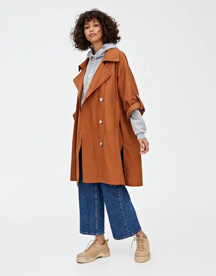 Trench con corte oversize, cierre de botones frontal a contraste y manga larga,  39,99 euros .