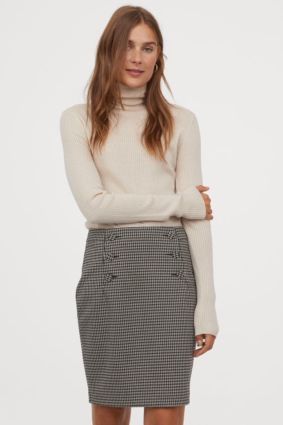 Falda corta con estampado pata de gallo y botones laterales. 100% elegante. (29,99 euros).