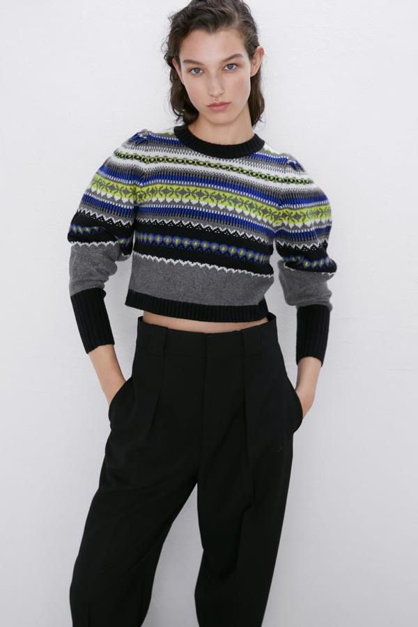 Jersey de punto con cuello redondo y manga larga, con un bonito dibujo de grecas y largo crop (Zara, 25,95 euros).