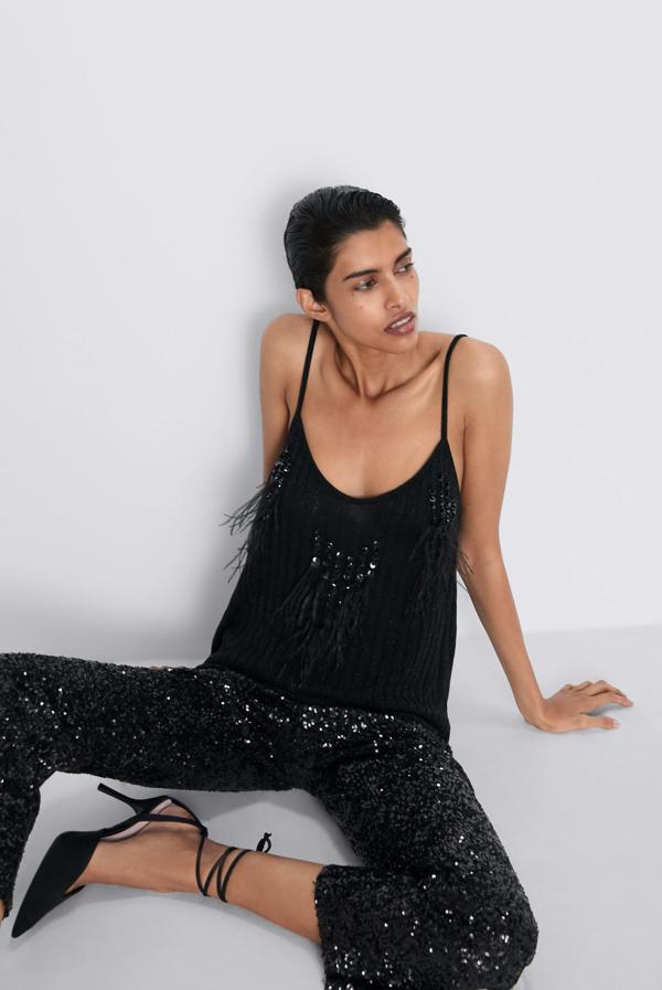 Si buscas un top que una plumas y lentejuelas este con escote de pico y tirantes finos puede ser una buena opción. Puedes encontrarlo en Zara por 22,95 euros y en las tallas S, M y L.