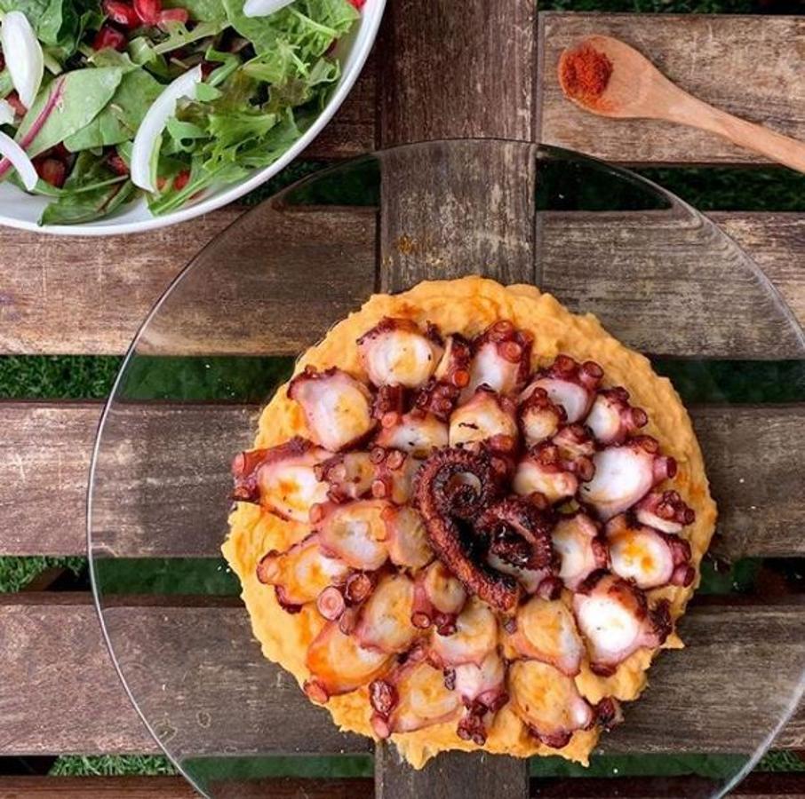 Ingredientes:-1 patata grande-2 patas de pulpo cocidas-60 ml de bebida de soja-Aceite-Pimentón picante-Una pizca de salPreparación:Cocer la patata hasta que esté muy tierna.Preparar el pulpo a la plancha sin salar.Una vez esté la patata hecha, chafar con un tenedor y añadir sal, 1 c/p de pimentón picante, 2 c/s de aceite y la bebida de soja.Remover durante 5 minutos hasta que quede una textura cremosa. Puedes añadir más bebida de soja si ves que no queda bien.Emplatar y colocar el pulpo cortado por encima.Salar y añadir un pelín más de aceite con pimentón.