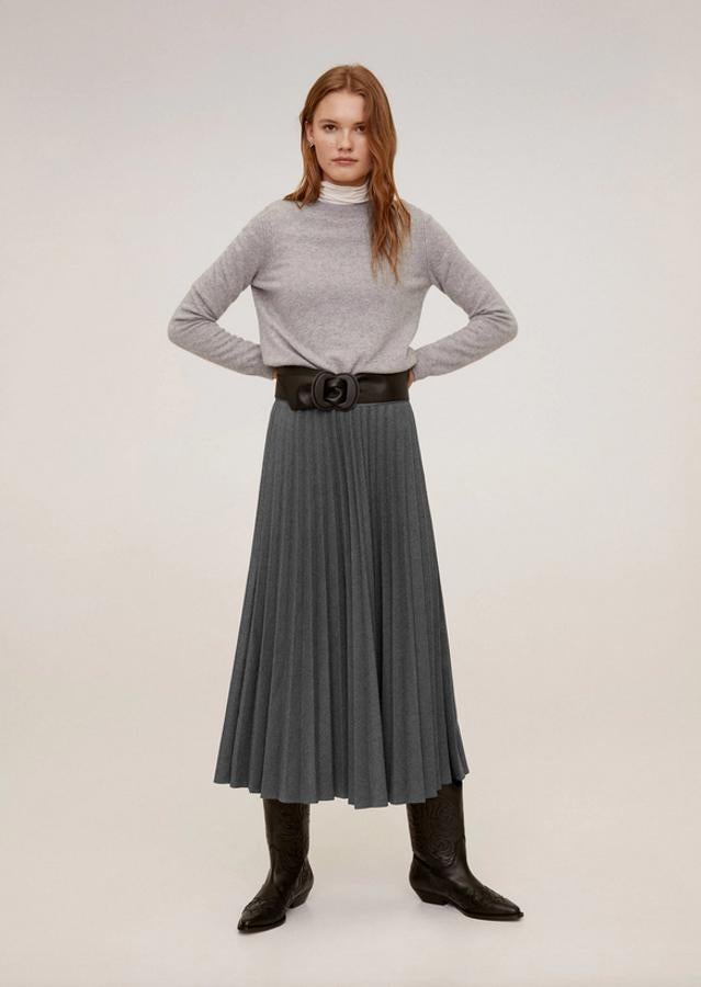 En su versión más clásica, pero no por ello menos necesaria. La falda midi plisada de Mango en color gris tiene diseño acampanado y el cinturón de la imagen no forma parte de la prenda. Cuesta 39,99 euros y está disponible entre las tallas S y L.